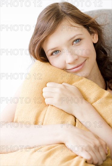 Teenage girl hugging pillow. Date : 2008