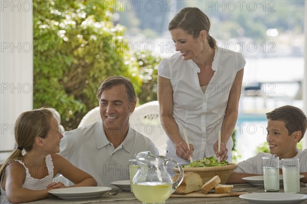 Family eating on porch.