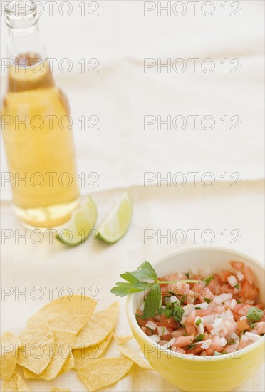 Close up of salsa, tortilla chips and beer. Date : 2008