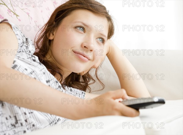 Teenage girl watching television. Date : 2008