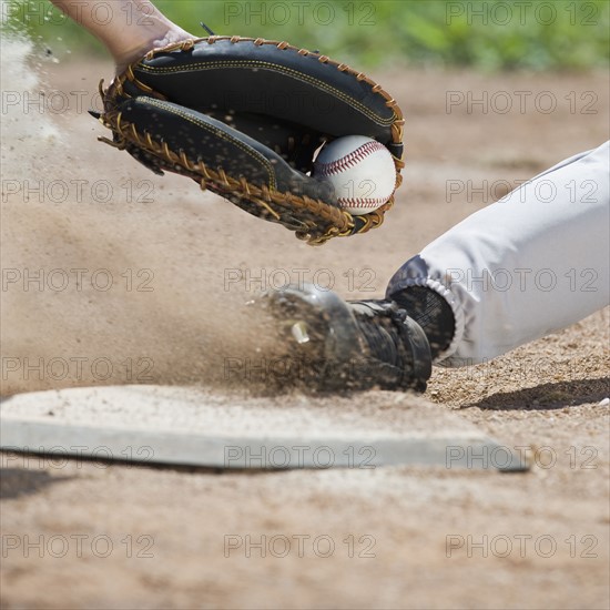 Close up of baseball player sliding into home plate.