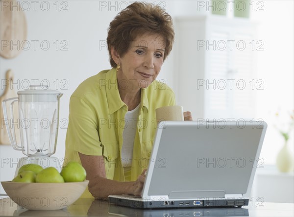 Senior woman using laptop.