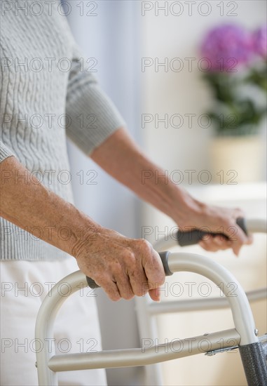 Senior woman using walker.