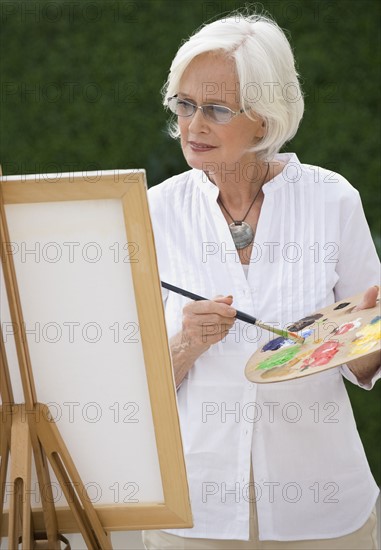 Senior woman painting.