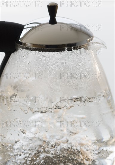 Close up of boiling water in tea pot.