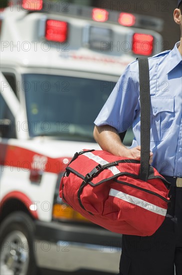 EMT carrying medical kit.