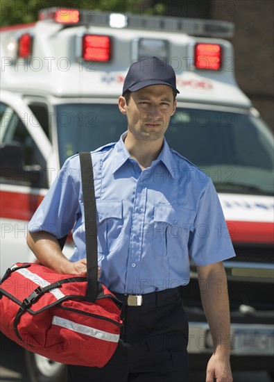 EMT carrying medical kit.