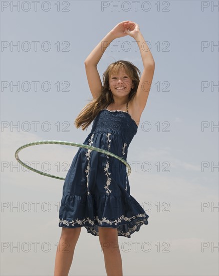 Girl hula hooping.