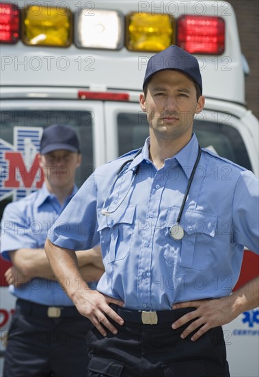 EMT’s posing in front of ambulance.