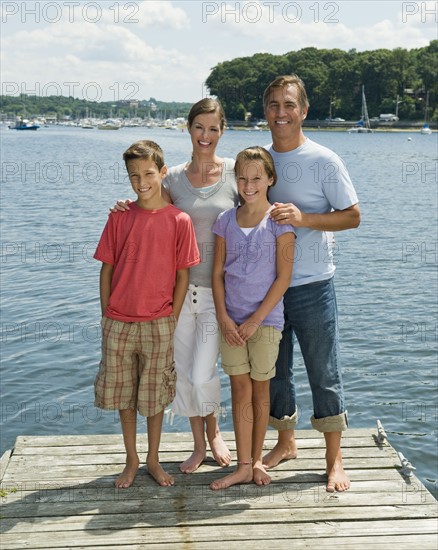 Family posing together on dock.