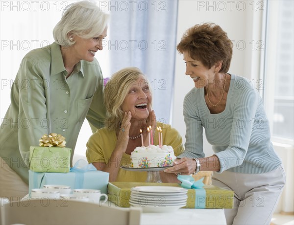 Senior women celebrating friend’s birthday .