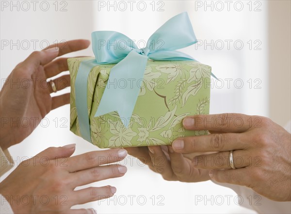 Man giving wife gift.