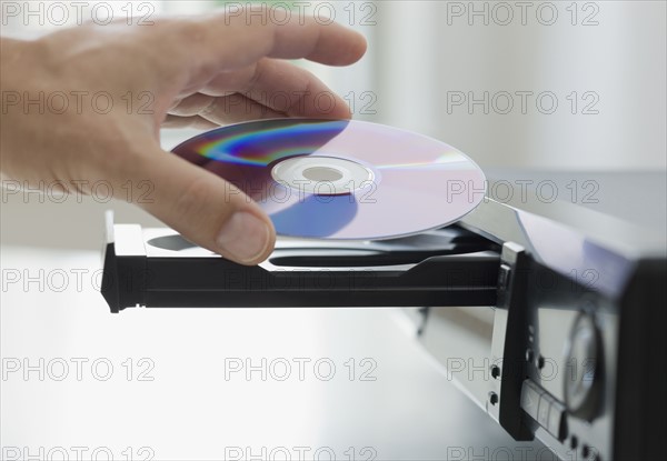 Man inserting dvd.