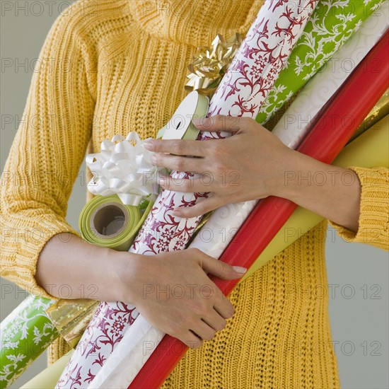 Woman holding wrapping paper.