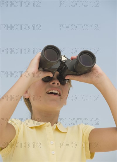 Girl looking through binoculars.