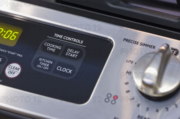 Close up of oven and stove controls.