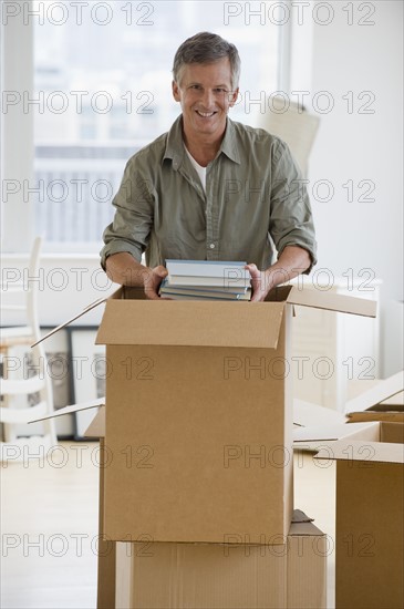 Man unpacking moving boxes.