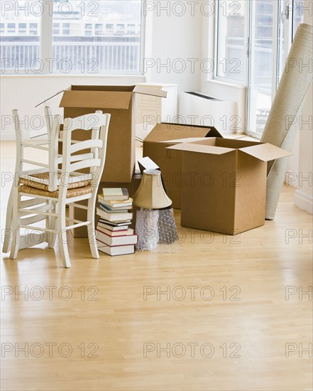 Moving boxes and chairs in livingroom.