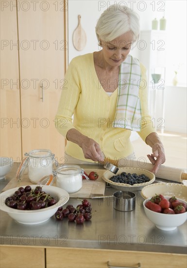 Senior woman making pies.