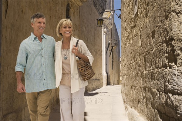 Tourists walking in alley.