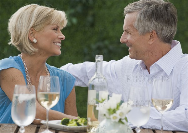 Couple enjoying wine outdoors.