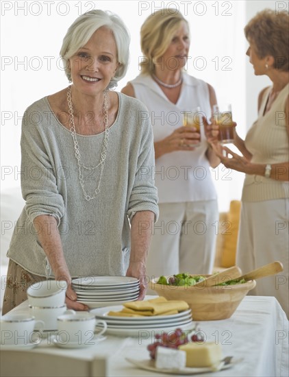 Senior women socializing at luncheon.