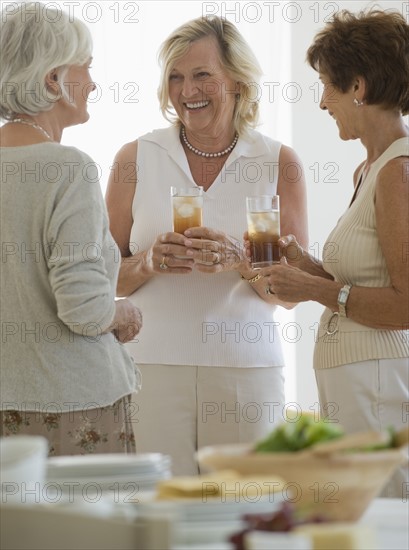 Senior women socializing at luncheon.