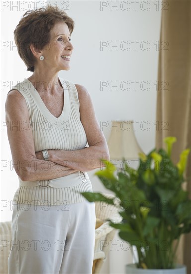 Senior woman looking out window.