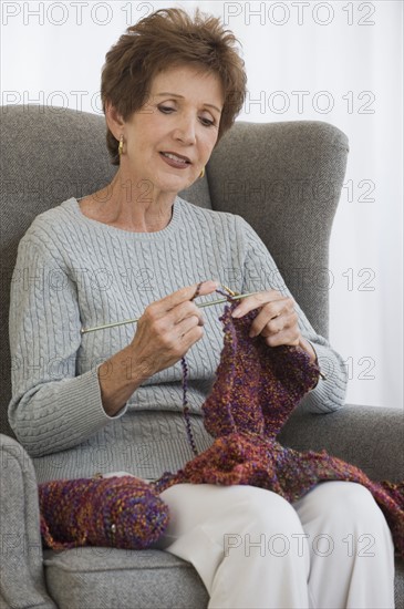 Senior woman knitting.