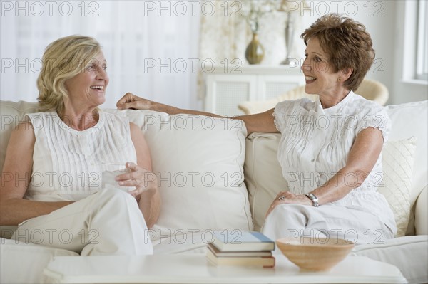 Senior women socializing in livingroom.