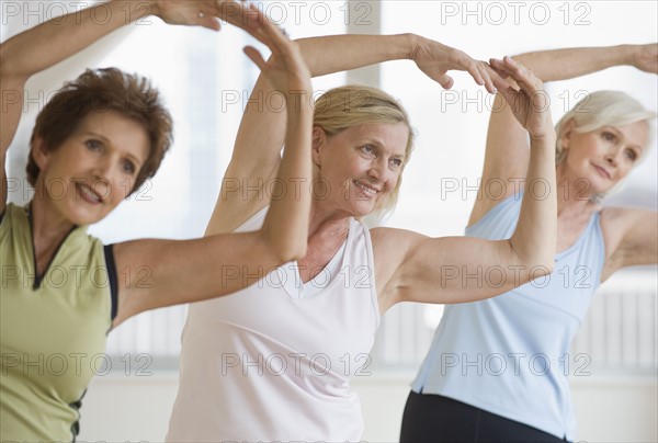 Senior women doing yoga.