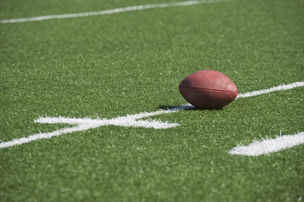 Football on yard line marker.