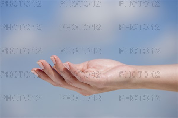 Close up of hand against sky.