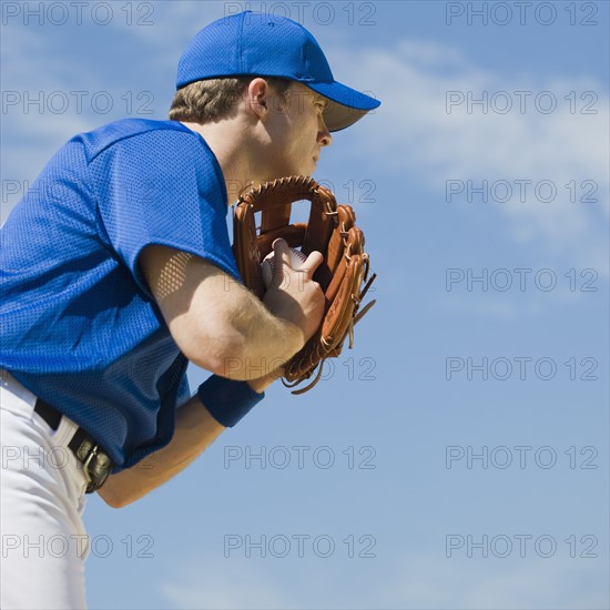 Baseball pitcher preparing to pitch ball.