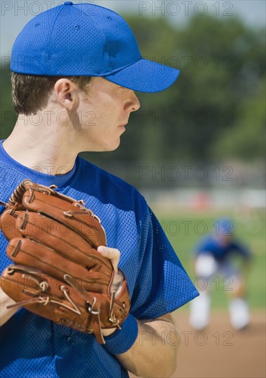 Baseball pitcher preparing to pitch ball.