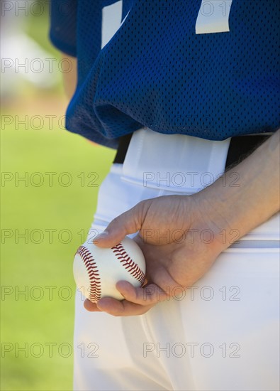 Baseball pitcher preparing to pitch ball.