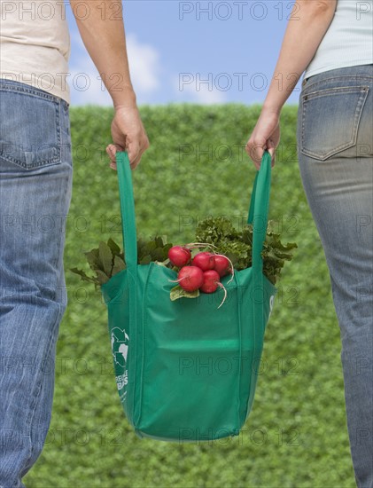 Couple carrying organic produce.