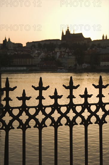 Silhouetted fence post and river.