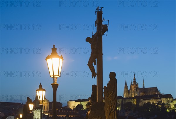 Night view of crucifix and cathedral.