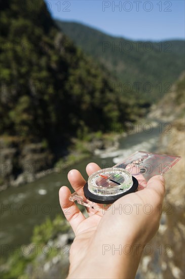 Hiker holding compass. Date : 2008