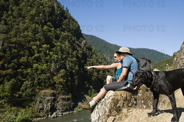 Hikers relaxing on river overlook. Date : 2008