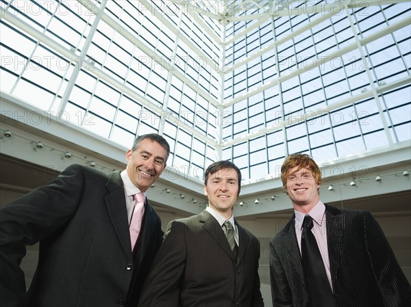 Businessmen posing in convention center atrium. Date : 2008