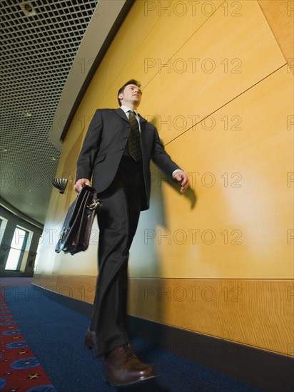 Businessman walking in corridor. Date : 2008