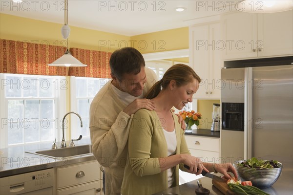 Couple making dinner in kitchen. Date : 2008