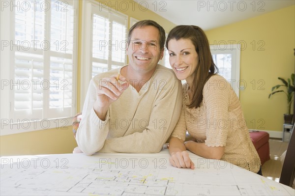 Couple reviewing house blueprints. Date : 2008