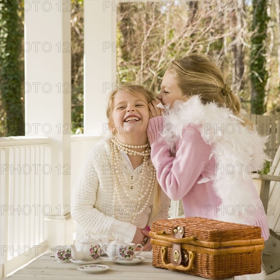 Girls having tea party on porch. Date : 2008