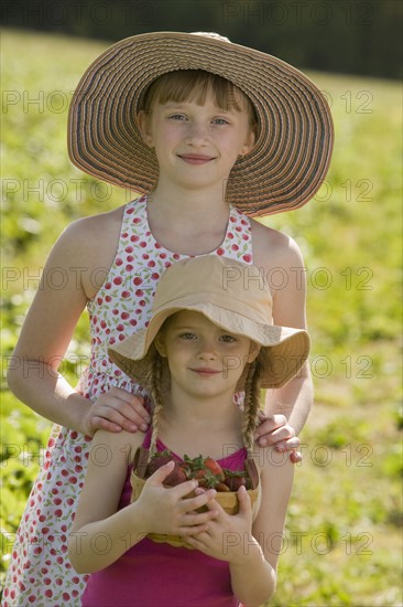 Girls picking fresh strawberries. Date : 2008