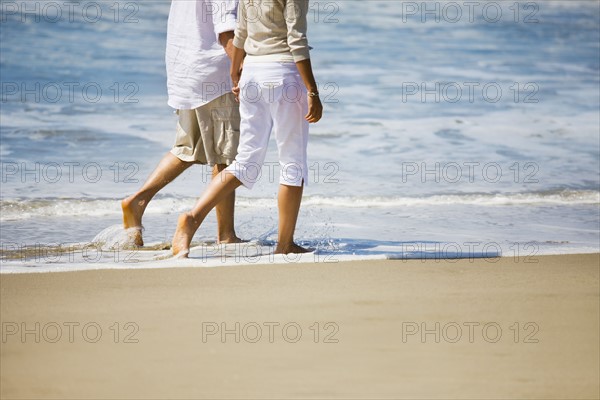 Couple walking on beach. Date : 2008