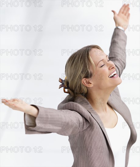 Happy businesswoman celebrating with arms outstretched. Date : 2008