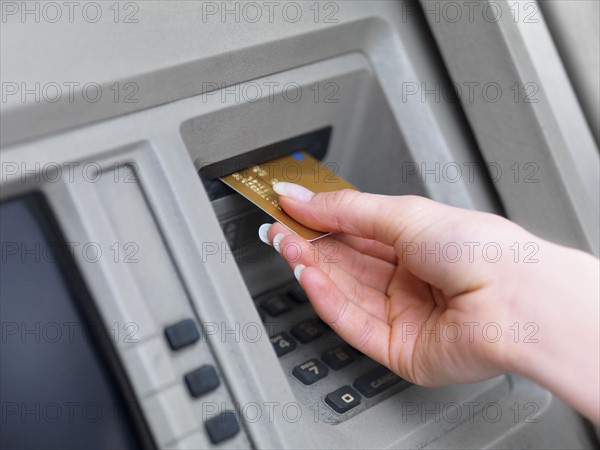 Woman using cash machine. Date : 2008